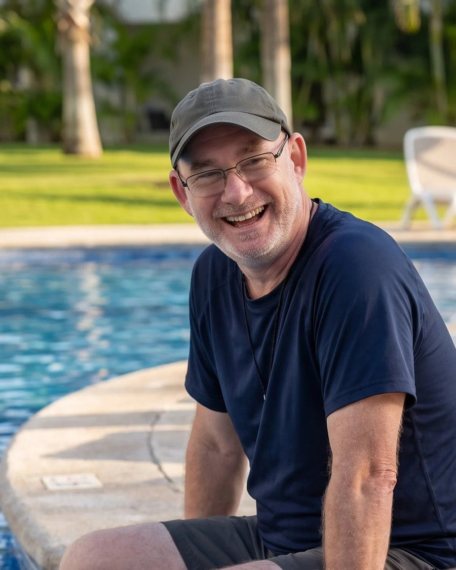 Chris Kenmore laughing at the edge of a resort pool