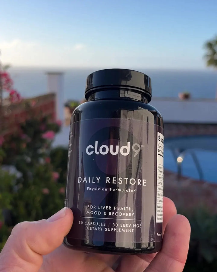 Holding Daily Restore above the ocean