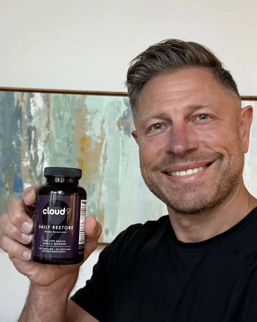 Mike Hardenbrook, founder of Cloud9, holding a bottle of Daily Restore
