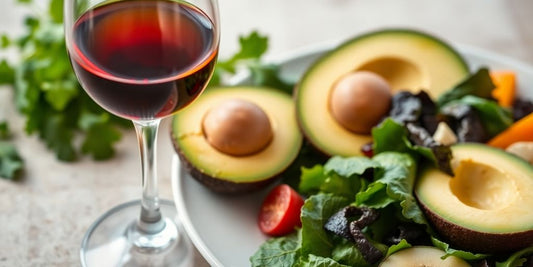 Glass of alcohol with healthy foods in the background.