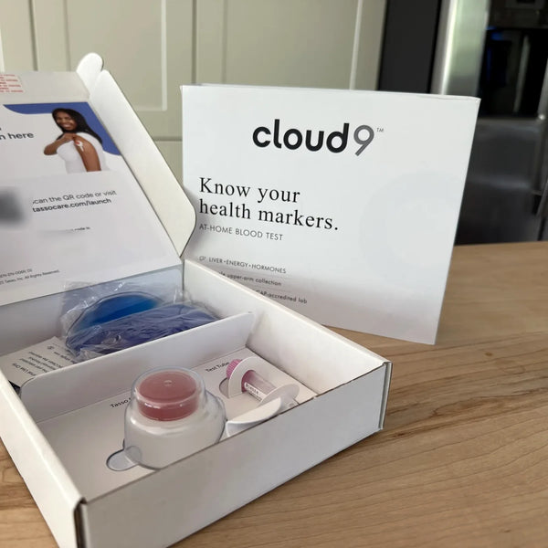 The Cloud9 at-home blood test kit, opened, with the collection device and the Know your health markers card