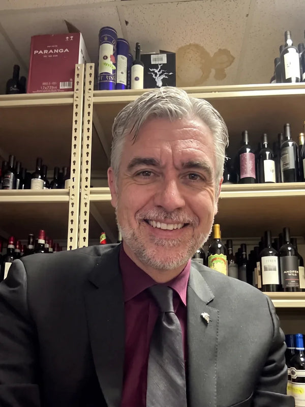 Rob, a sommelier, in his wine cellar