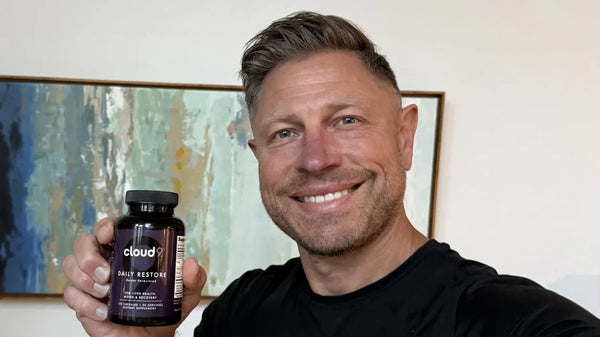 Mike Hardenbrook holding a bottle of Daily Restore